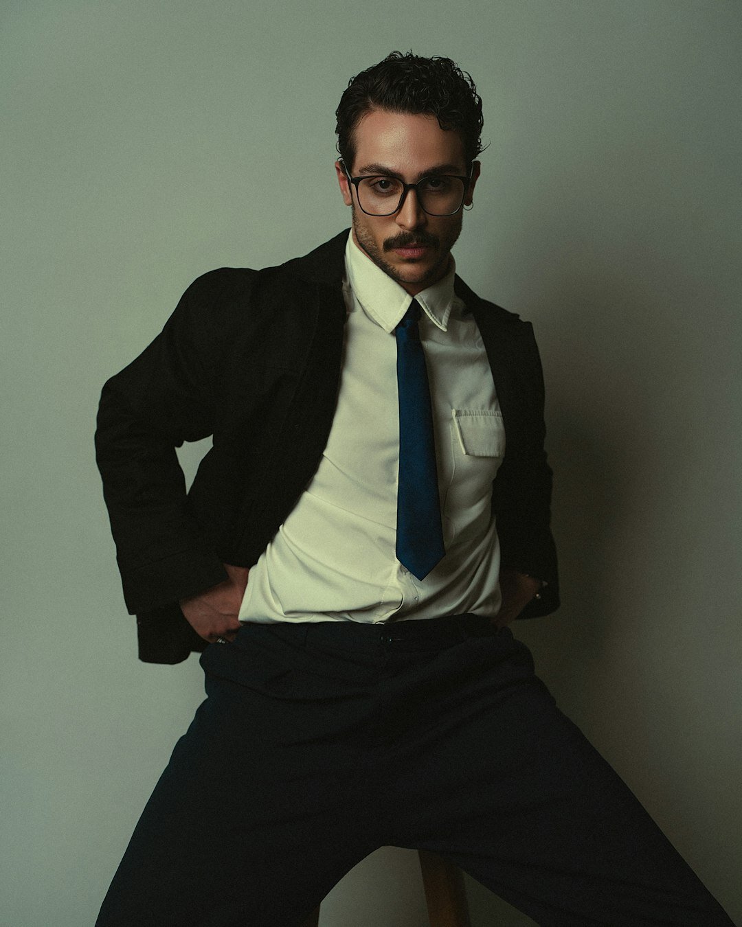 Studio portrait of a man with glasses in business casual clothing